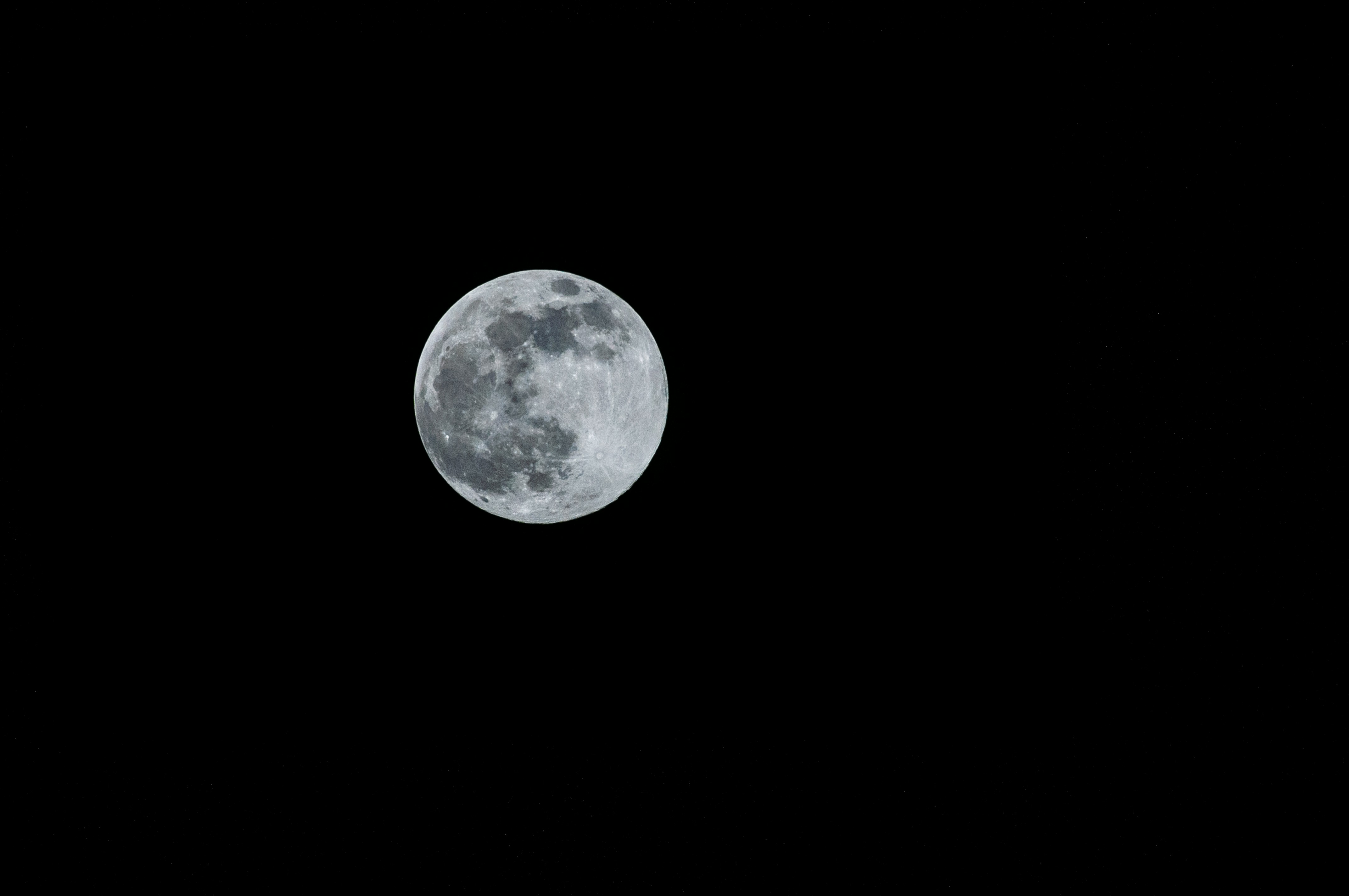 Full moon with detailed surface features against black background